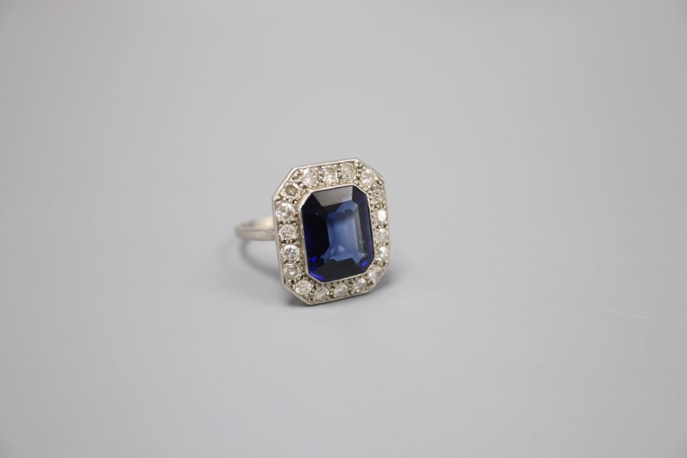 A platinum synthetic sapphire and diamond octagonal cluster ring, size O